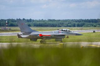 An F-16 Fighting Falcon airplane on runway at Ramstein Air Base in Germany